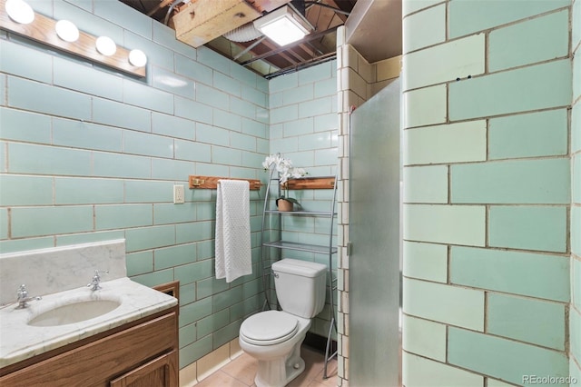 bathroom with tile patterned flooring, vanity, and toilet