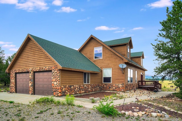 log-style house with a garage and a deck