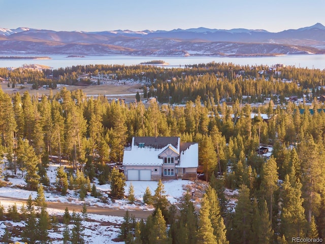 drone / aerial view with a water and mountain view