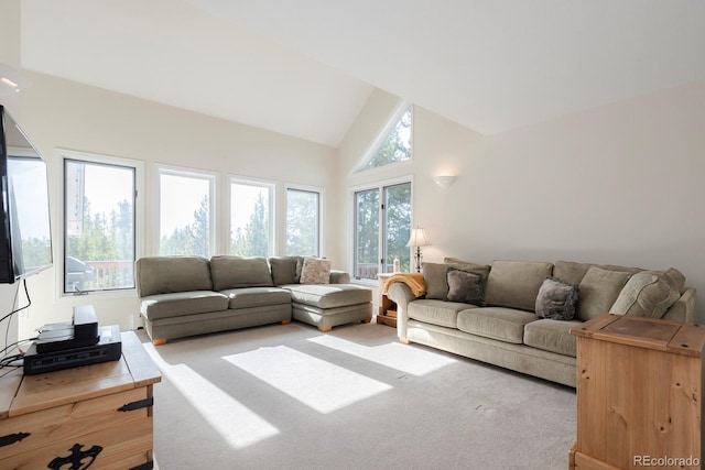 living room with high vaulted ceiling and light colored carpet