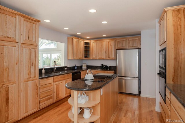 kitchen featuring a sink, open shelves, light wood-type flooring, and black appliances
