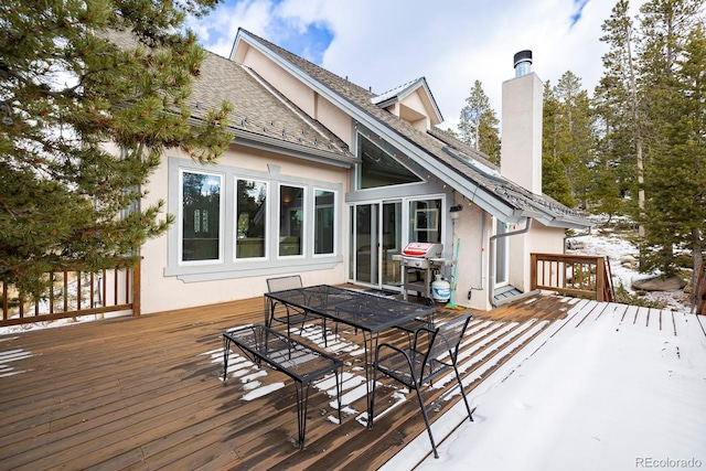 wooden terrace featuring outdoor dining area and grilling area