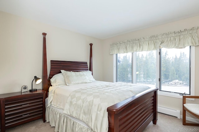 bedroom with carpet floors, a baseboard radiator, and multiple windows