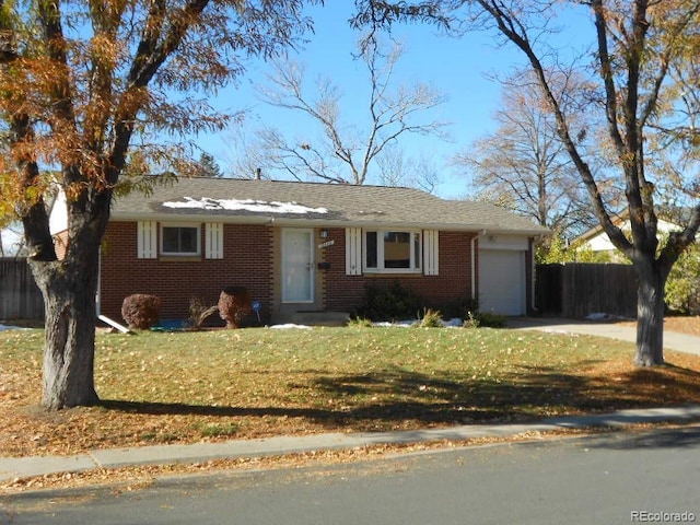 ranch-style home with a garage and a front lawn