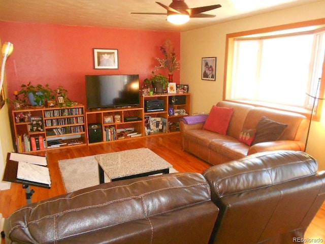 living room featuring ceiling fan and wood-type flooring