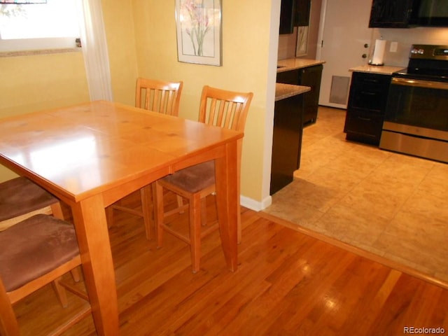 dining space featuring light hardwood / wood-style floors