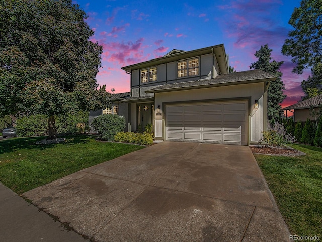 view of front facade with a garage and a lawn