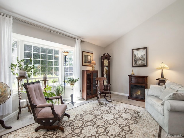 sitting room featuring lofted ceiling and light tile patterned flooring