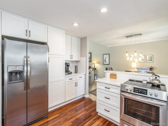 kitchen with stainless steel appliances, dark hardwood / wood-style floors, pendant lighting, and white cabinetry