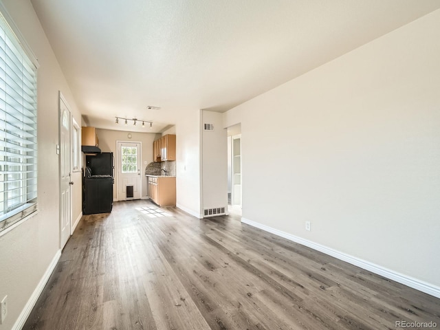 unfurnished living room featuring wood-type flooring