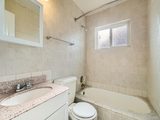 bathroom featuring vanity, toilet, and tile walls