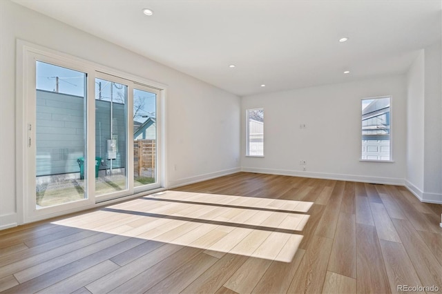 spare room with recessed lighting, baseboards, and light wood-style floors