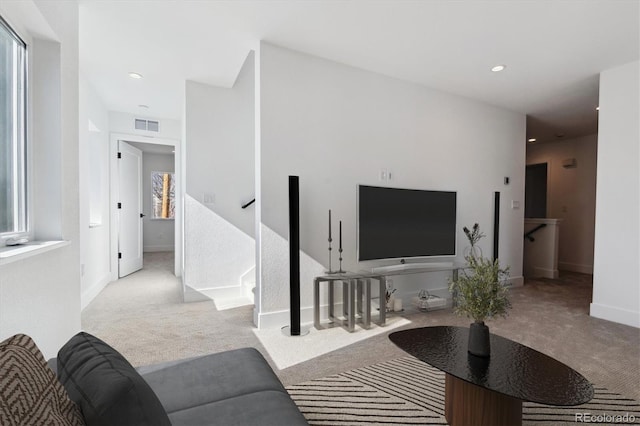 carpeted living area with stairs, recessed lighting, visible vents, and baseboards