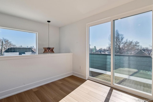 unfurnished room featuring dark wood-type flooring and baseboards