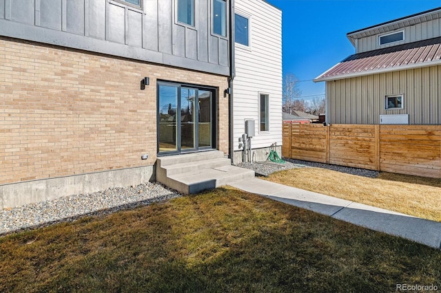 view of yard with entry steps and fence