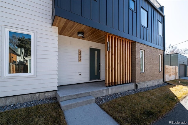 3432 W 25th Ave, Denver, CO 80211 - view of exterior entry featuring covered porch, board and batten siding, and brick siding