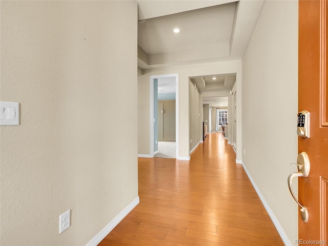 corridor with recessed lighting, light wood-type flooring, and baseboards