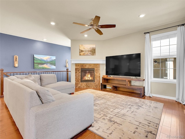 living room featuring ceiling fan, recessed lighting, a fireplace, and wood finished floors