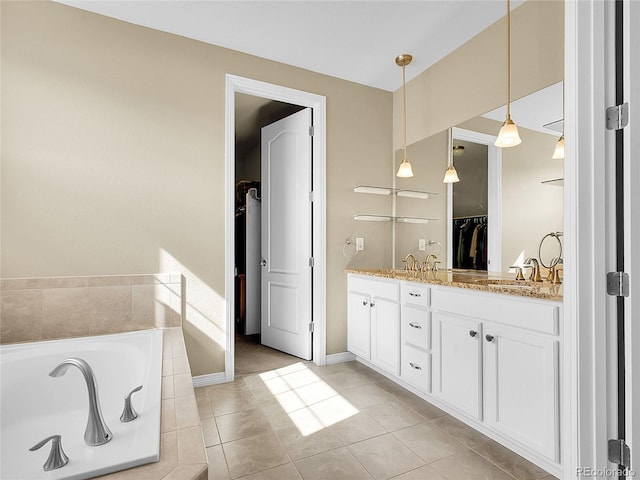 bathroom with tiled bath, a sink, a spacious closet, tile patterned floors, and double vanity