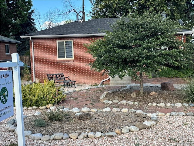 1210 Vance St, Lakewood, CO 80214 - view of front of house with brick siding and roof with shingles
