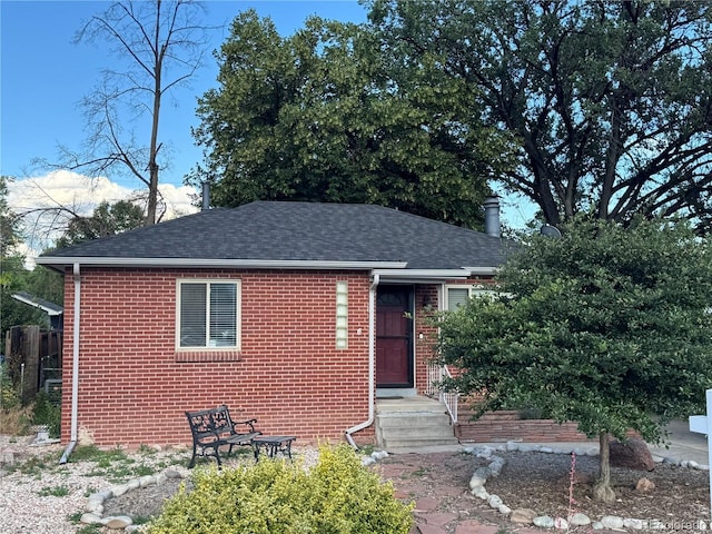 1210 Vance St, Lakewood, CO 80214 - view of front of property featuring a shingled roof and brick siding
