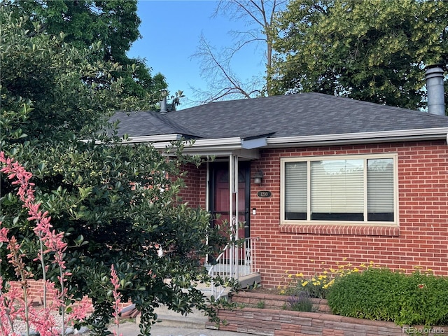 1210 Vance St, Lakewood, CO 80214 - view of front of house with brick siding and a shingled roof