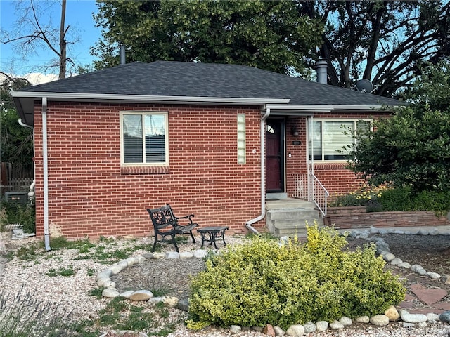 1210 Vance St, Lakewood, CO 80214 - view of front of property featuring brick siding and roof with shingles