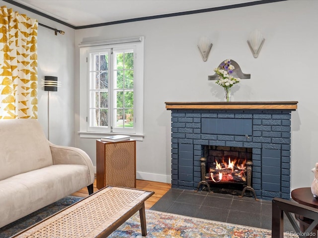 sitting room featuring a fireplace, wood-type flooring, and ornamental molding