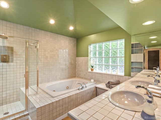 bathroom featuring vanity and separate shower and tub