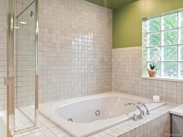 bathroom featuring separate shower and tub