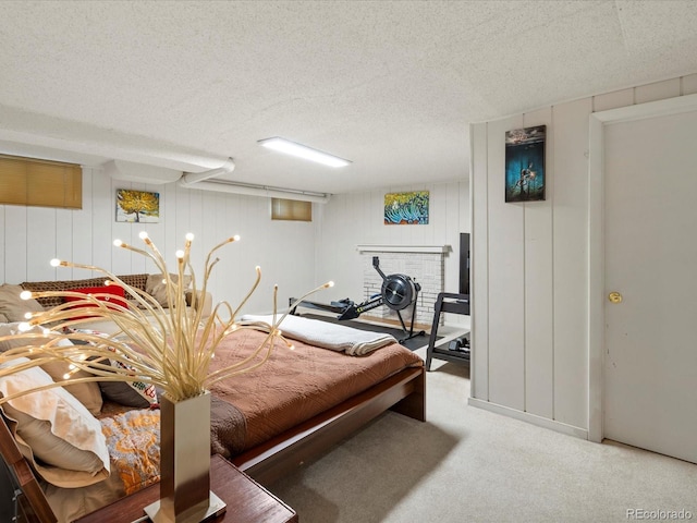 carpeted bedroom with a fireplace and a textured ceiling