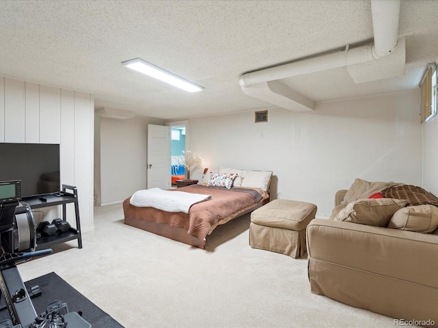 bedroom with carpet flooring and a textured ceiling