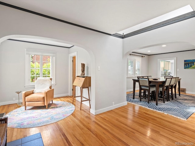 dining area featuring crown molding, light hardwood / wood-style flooring, and plenty of natural light