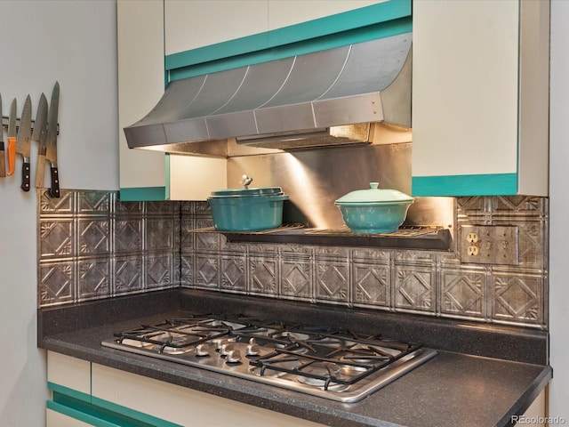 kitchen featuring white cabinets, exhaust hood, backsplash, and stainless steel gas cooktop