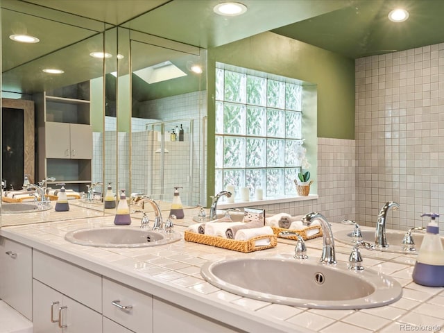 bathroom featuring vanity and a shower with door