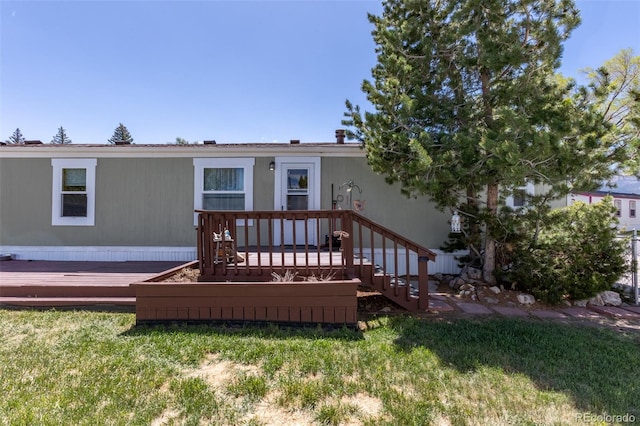 910 J St Unit D1, Salida, CO 81201 - rear view of property with a deck and a yard