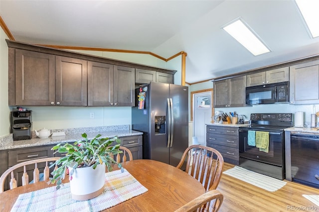 910 J St Unit D1, Salida, CO 81201 - kitchen featuring black appliances, vaulted ceiling, dark brown cabinetry, light stone countertops, and light wood-type flooring