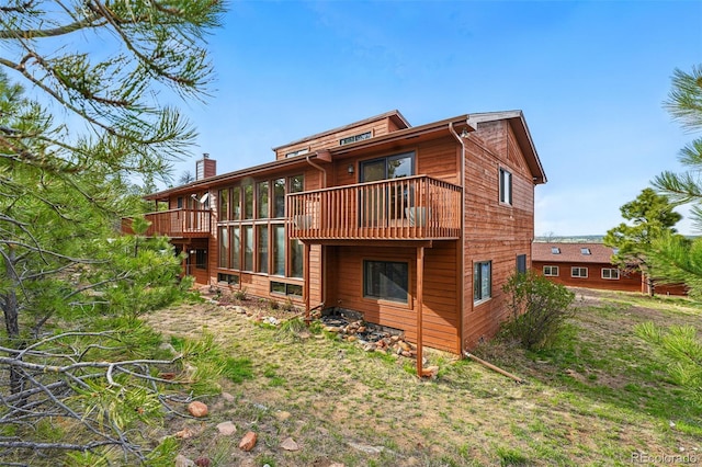 2100 Bibles Hill Dr, Franktown, CO 80116 - back of property featuring a balcony and a chimney