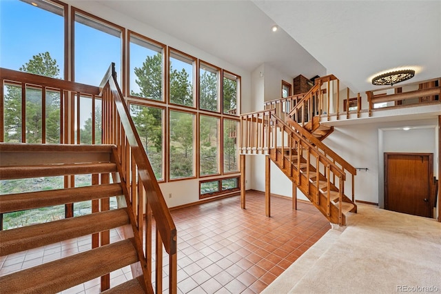 2100 Bibles Hill Dr, Franktown, CO 80116 - staircase featuring tile patterned floors, a high ceiling, baseboards, and recessed lighting