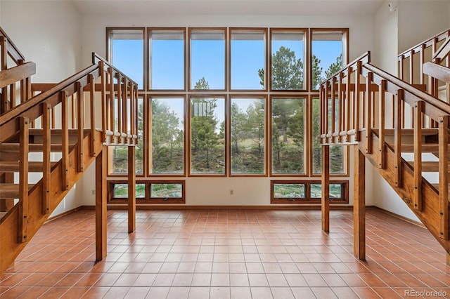 2100 Bibles Hill Dr, Franktown, CO 80116 - unfurnished living room with stairway, tile patterned floors, and baseboards