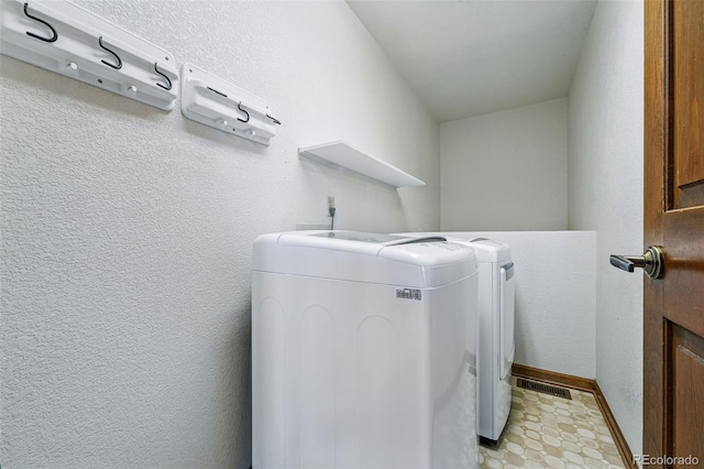 2100 Bibles Hill Dr, Franktown, CO 80116 - clothes washing area with independent washer and dryer, light floors, and baseboards