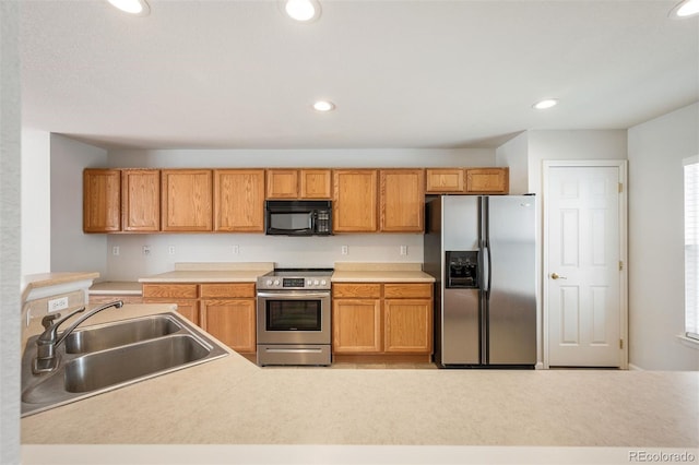 kitchen with recessed lighting, a sink, and appliances with stainless steel finishes