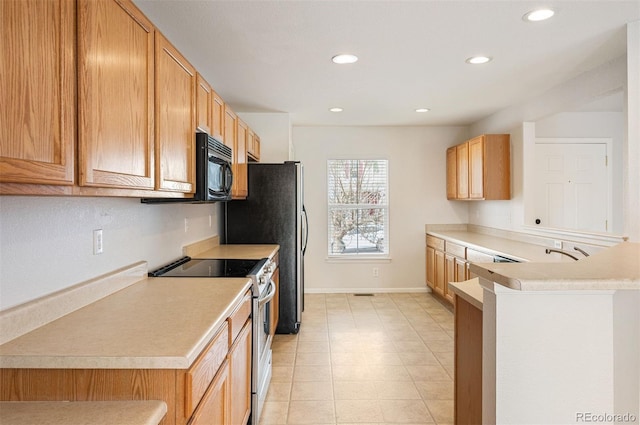 kitchen featuring baseboards, light countertops, stainless steel electric stove, black microwave, and recessed lighting