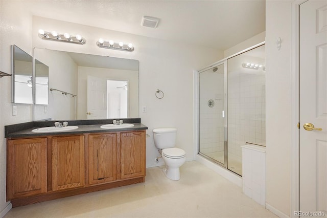 full bathroom featuring a sink, toilet, and a shower stall