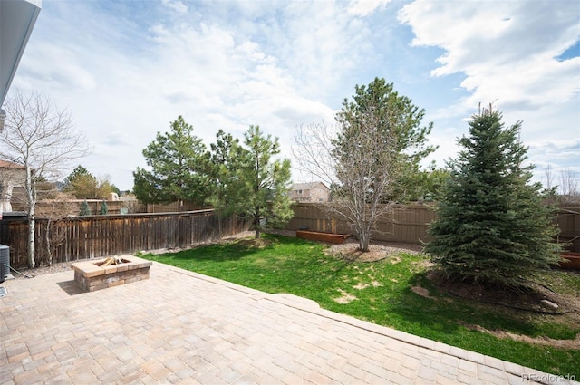 view of patio / terrace featuring an outdoor fire pit, a fenced backyard, and central AC