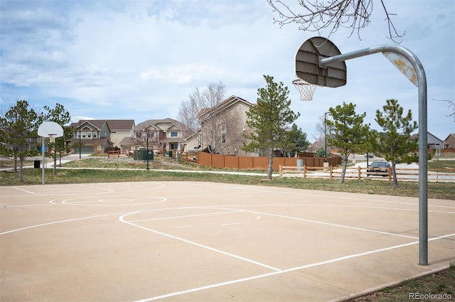 view of basketball court with a residential view, fence, and community basketball court