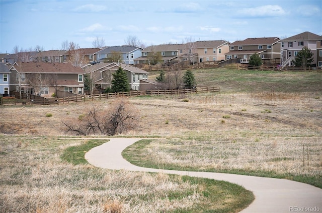 view of yard featuring fence and a residential view