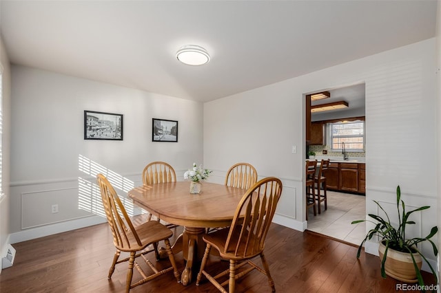 dining area with sink and light wood-type flooring