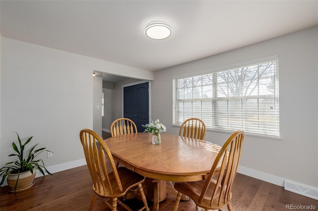 dining space with dark hardwood / wood-style floors