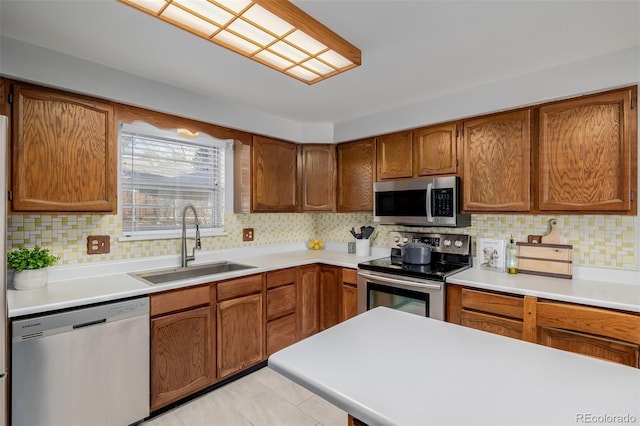 kitchen featuring tasteful backsplash, sink, and appliances with stainless steel finishes